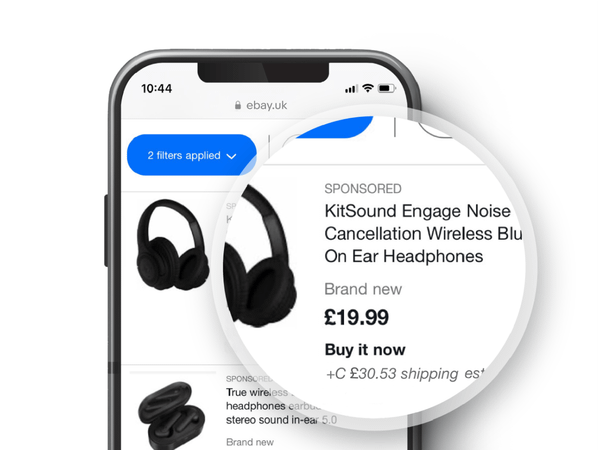 A magnified image of an eBay listing for headphones displayed on a phone.